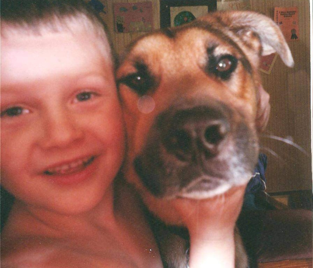 Young Kyle with our dog Chompers. When we brought him home, he truly wanted to chomp Kyle's face off. Eventually they became the best of friends.